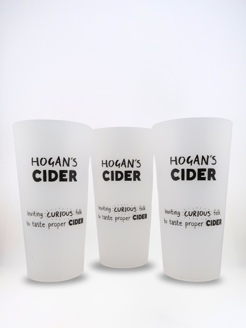 Three Hogan’s Cider reusable EcoCups – pint-sized cups printed with our ‘Inviting Curious Folk’ design.
