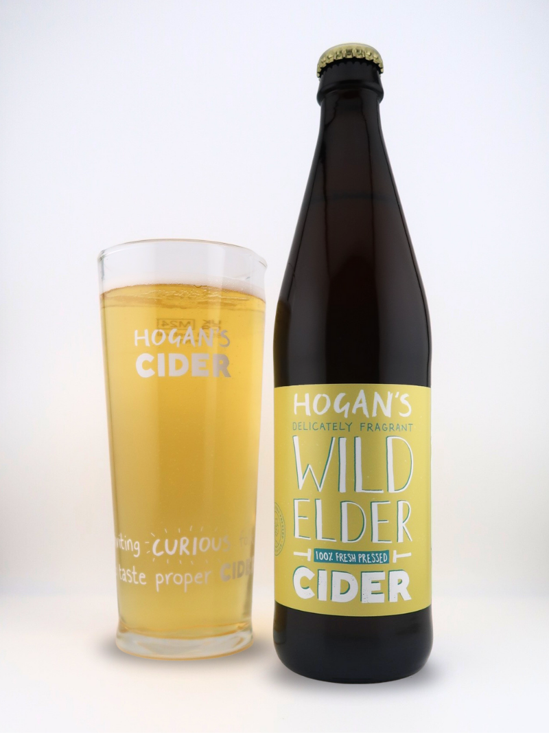 Hogan’s Wild Elder 500 ml elderflower cider bottle and pint glass – fresh-pressed craft cider infused with natural elderflower.
